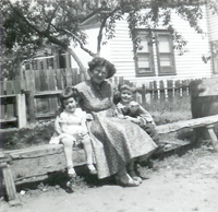 Roseanne McKeever with her mom Rose and brother Mike in their Grandparent's backyard on Franklin Street in Trenton, NJ, circa 1955 